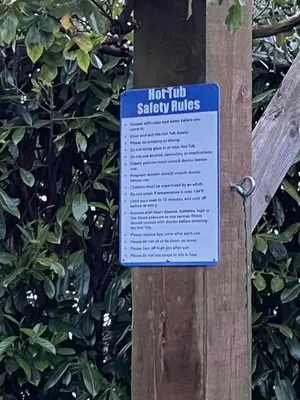 a sign on a tree that says hot tub slaveryuds at River Mill Retreat in Little Hallingbury