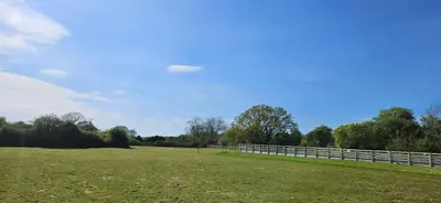 a fence in a field next to a field at Lilys Cottage - Sleeps 2 - Pet friendly in Stowmarket