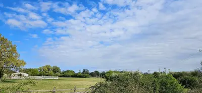 a field with a kite flying in the sky at Lilys Cottage - Sleeps 2 - Pet friendly in Stowmarket