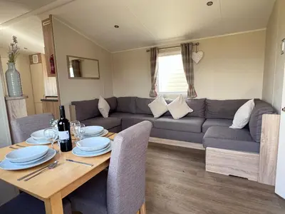 a living room with a table and a couch at Modern & Blissful Beach Park Holiday Home in Dovercourt, Essex, in Parkeston