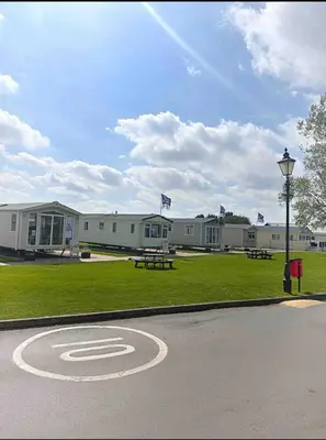 a building with a picnic table and a street light at Modern & Blissful Beach Park Holiday Home in Dovercourt, Essex, in Parkeston