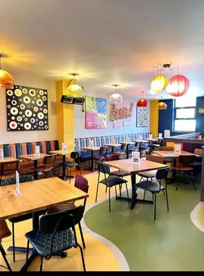 a dining room with wooden tables and chairs at Modern & Blissful Beach Park Holiday Home in Dovercourt, Essex, in Parkeston