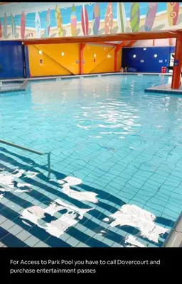 a large swimming pool with blue water at Modern & Blissful Beach Park Holiday Home in Dovercourt, Essex, in Parkeston