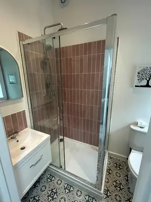 a bathroom with a shower and a sink and a toilet at Charming Kings road in Bury Saint Edmunds