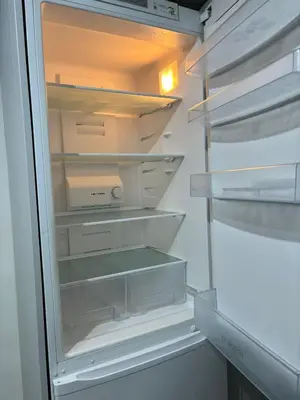 an empty refrigerator with its door open at Spacious House Near Cambridge - Free Parking and Garden in Cambridge