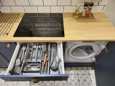 an open drawer in a kitchen with a washing machine at Sizewell - Contractors - Free Parking - Vacation in Leiston