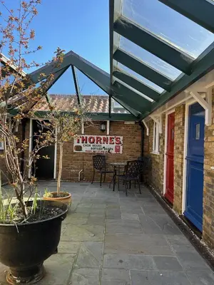 awning over a patio with a sign that reads honors at The Prince of Wales in Purleigh