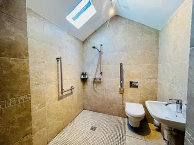 a bathroom with a shower and a toilet and a sink at The Prince of Wales in Purleigh
