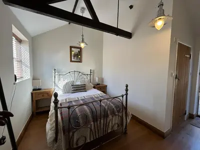 a bedroom with a metal bed in a room at The Prince of Wales in Purleigh