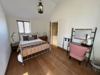 a bedroom with a bed and a desk and a chair at The Prince of Wales in Purleigh