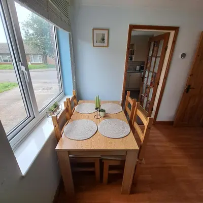 a dining room with a table with plates on it at Cute little 2 bed near Cambridge in Fenstanton