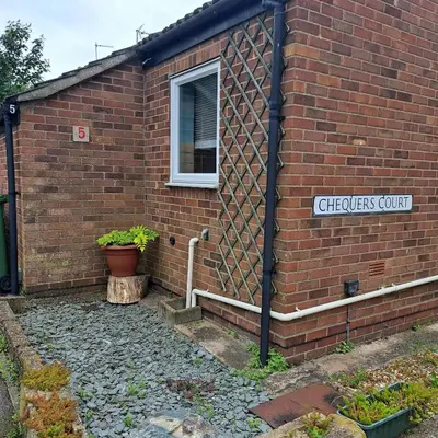 a brick building with a sign that reads chickens court at Cute little 2 bed near Cambridge in Fenstanton