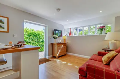 a living room with a red couch and some windows at 1 Bed in Cratfield oc-t29434 in Cratfield