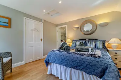 a bedroom with a blue bed and a mirror at 1 Bed in Cratfield oc-t29434 in Cratfield