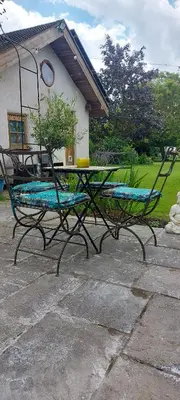 a bench with a potted plant on top of it at Straw Bale Cottage in Halesworth