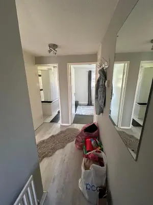 a hallway of a house with a room with a mirror at DK House in Colchester