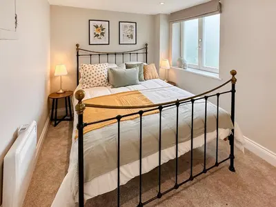 a bedroom with a bed and a window at The Church Rooms in Wenhaston