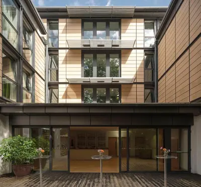 an external view of a building with glass doors at Murray Edwards College, Cambridge in Cambridge