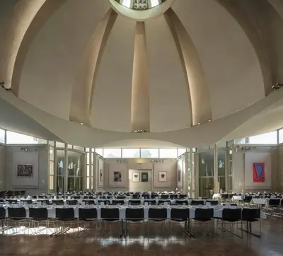 a large room filled with tables and chairs at Murray Edwards College, Cambridge in Cambridge