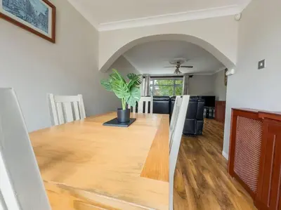 a dining room with a table with a potted plant at Cousy Haven in Laindon