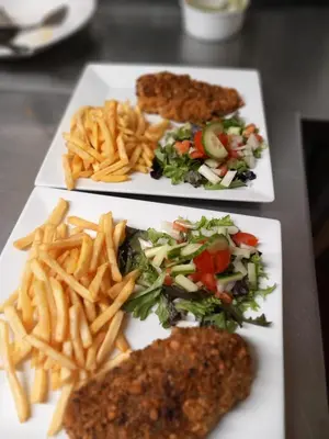 three plates of food with french fries and meat at The Chequers in Downham Market