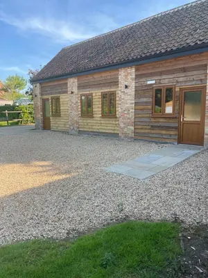 a house with a gravel driveway in front of it at The Chequers in Downham Market
