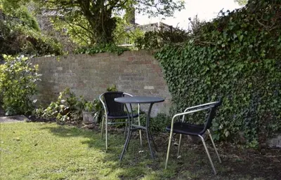two chairs and a table in a yard at The Chequers in Downham Market