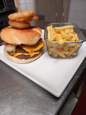 a sandwich and french fries on a white plate at The Chequers in Downham Market