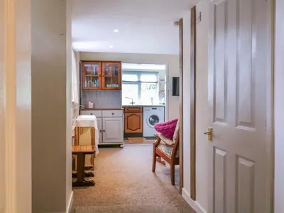 an open door to a kitchen with a sink at The Cottage in Sudbury