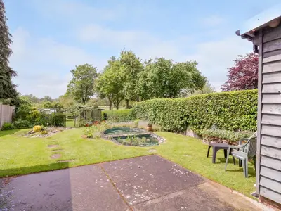 a garden with a pond in the yard at The Cottage in Sudbury