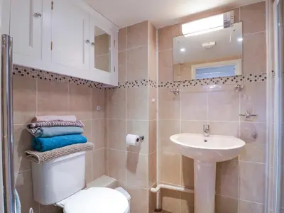 a bathroom with a toilet and a sink at The Cottage in Sudbury