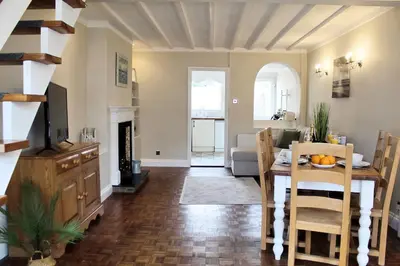 a living room with a table and a dining room at Cosy Cottage in Mersea - Walking distance to beach and town in West Mersea
