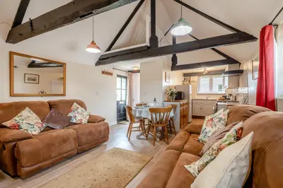 a living room with a couch and a table at The Old Dairy & The Old Stables in Thetford