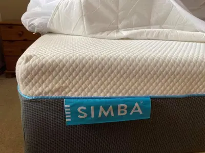 a mattress with a blue sign on top of it at The Old Dairy & The Old Stables in Thetford