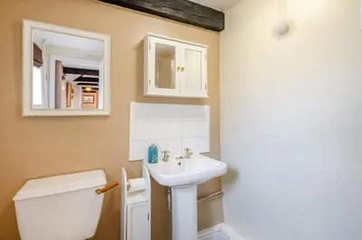 a bathroom with a sink and a toilet at The Old Dairy & The Old Stables in Thetford