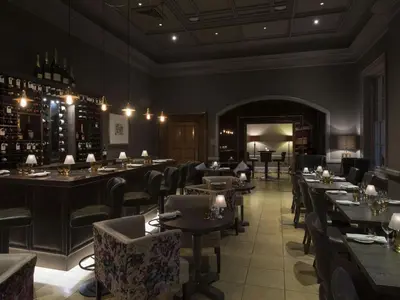 a restaurant with tables and chairs in a room at Bedford Lodge Hotel & Spa in Newmarket