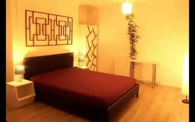 a bedroom with a large red bed in a room at Cambridge city centre accommodations in Cambridge