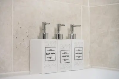 a trio of threeiliters sitting on top of a counter at Kingside Residence Stevenage in Stevenage