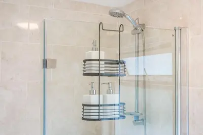 a bathroom with a shower with towels on a rack at Kingside Residence Stevenage in Stevenage