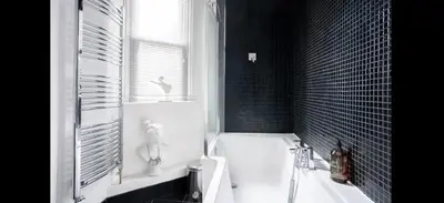a bathroom with a tub and a sink and a window at Stunning sea views from rooms and terraces in Leigh-on-Sea