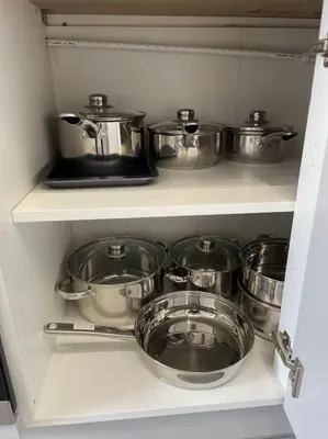 a shelf with many pots and pans in a kitchen at Nero view, Southend City High Street in Southend-on-Sea