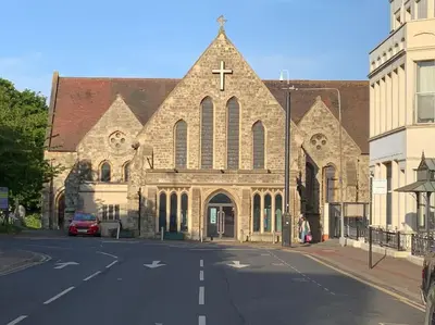 a large stone church with a cross on the front at Nero view, Southend City High Street in Southend-on-Sea