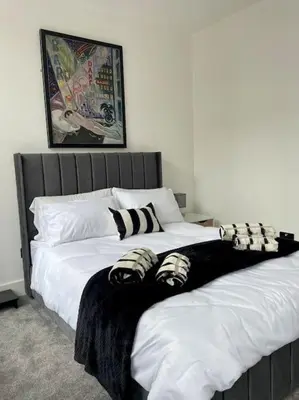 two beds in a bedroom with white and black at Nero view, Southend City High Street in Southend-on-Sea