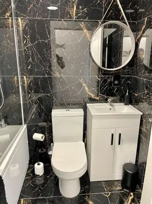 a bathroom with a toilet and a sink and a mirror at Nero view, Southend City High Street in Southend-on-Sea