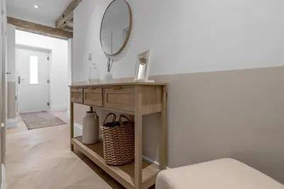 a bathroom with a vanity with a mirror on the wall at The old Stables in Wymondham