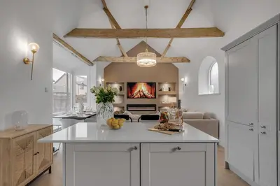a kitchen with a white island in a room at The old Stables in Wymondham
