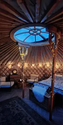 a room with a bed and a window in a yurt at The Isla Yurt in Colchester