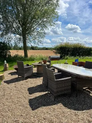 a patio with a table and chairs and a table and a tree at The Isla Yurt in Colchester