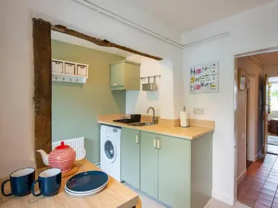 a kitchen with a sink and a dishwasher at Meadowland Holiday Cottage in Eye