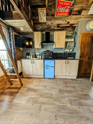 a kitchen with wooden cabinets and a counter at Lake View lodges The Lavenham in Long Melford